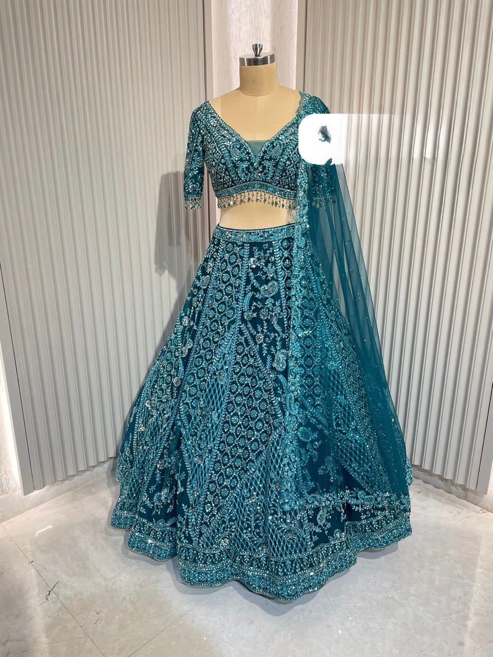 Tel blue net Lehnga with total hand work blouse & complete original Zirconia & mirror embellishments all over Lehnga