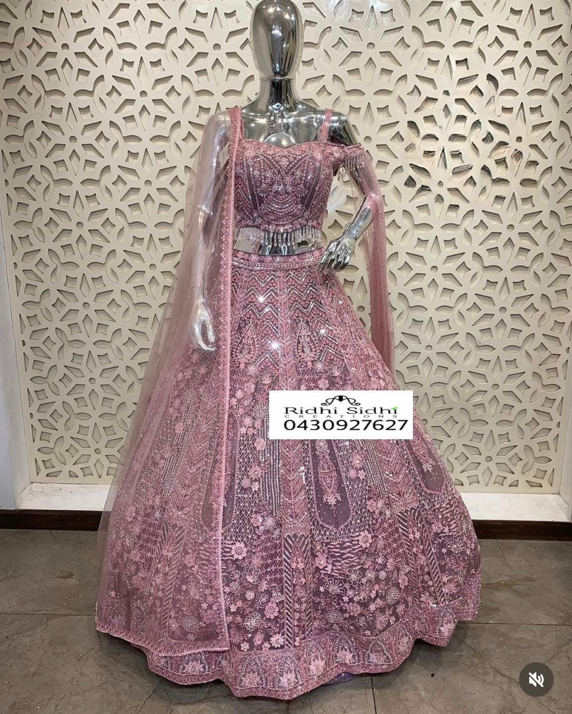 Dusty pink net Lehnga with heavily emberoidered Zari & seuin work with zirconia & stones embellishments